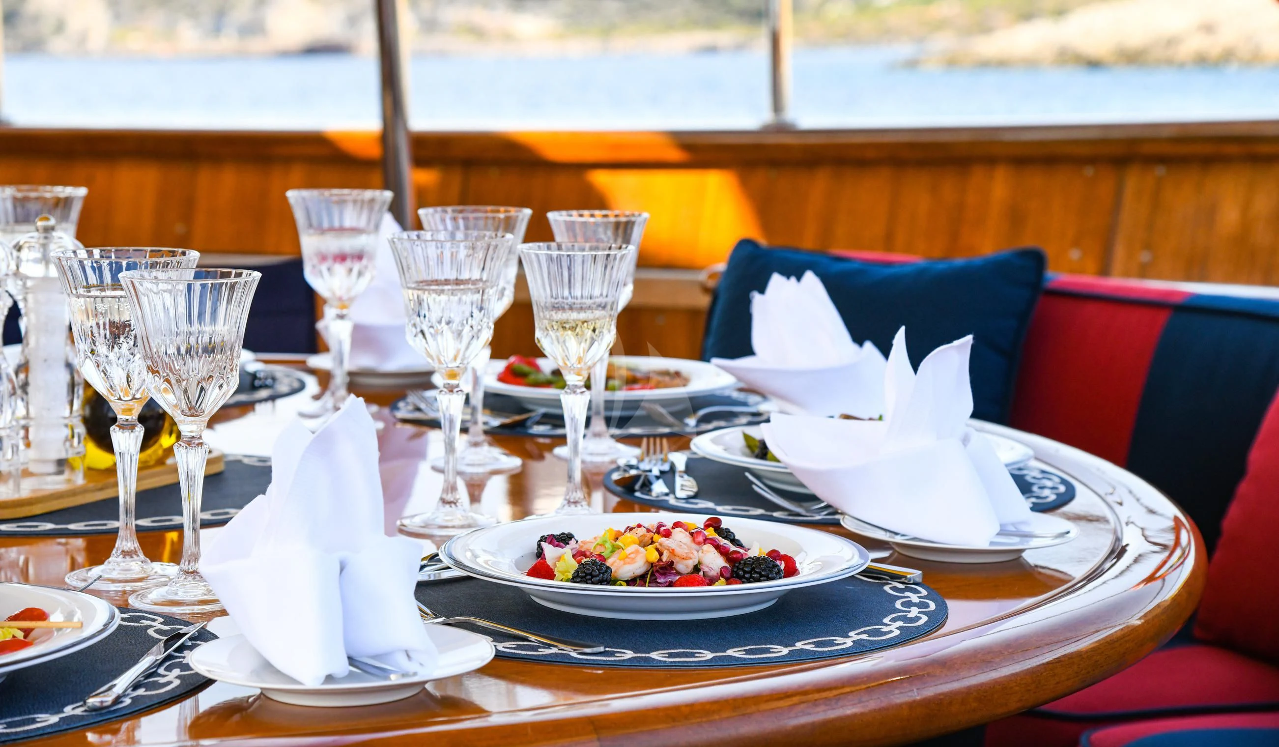a table with food and glasses on it aboard TAMARITA Yacht for Sale