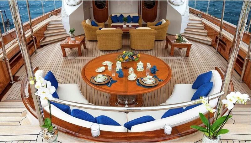 a table with candles and flowers on it aboard TAMARITA Yacht for Sale