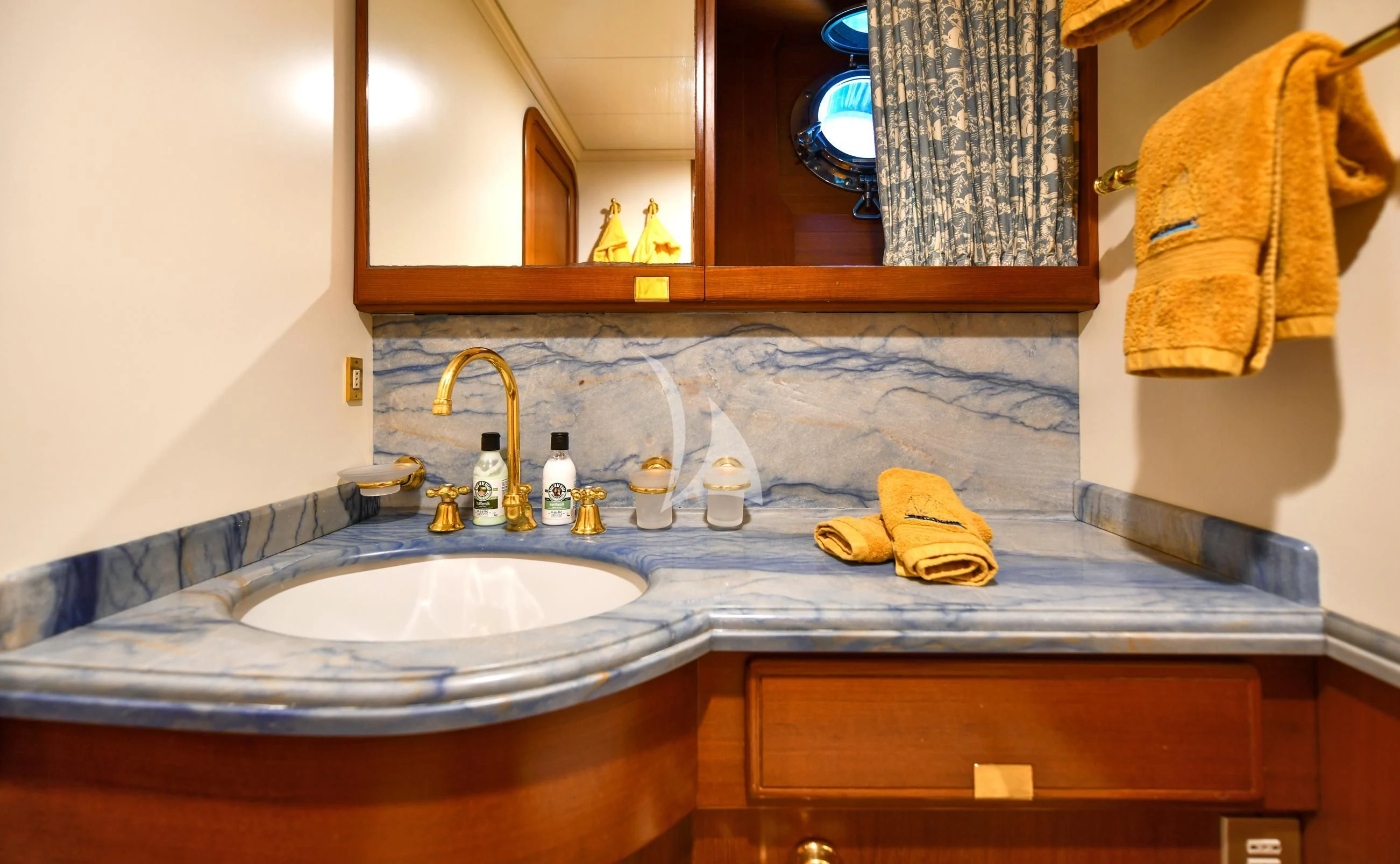 a bathroom with a sink and a mirror aboard TAMARITA Yacht for Sale
