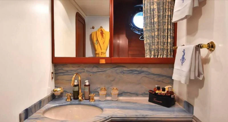 a bathroom with a large mirror aboard TAMARITA Yacht for Sale