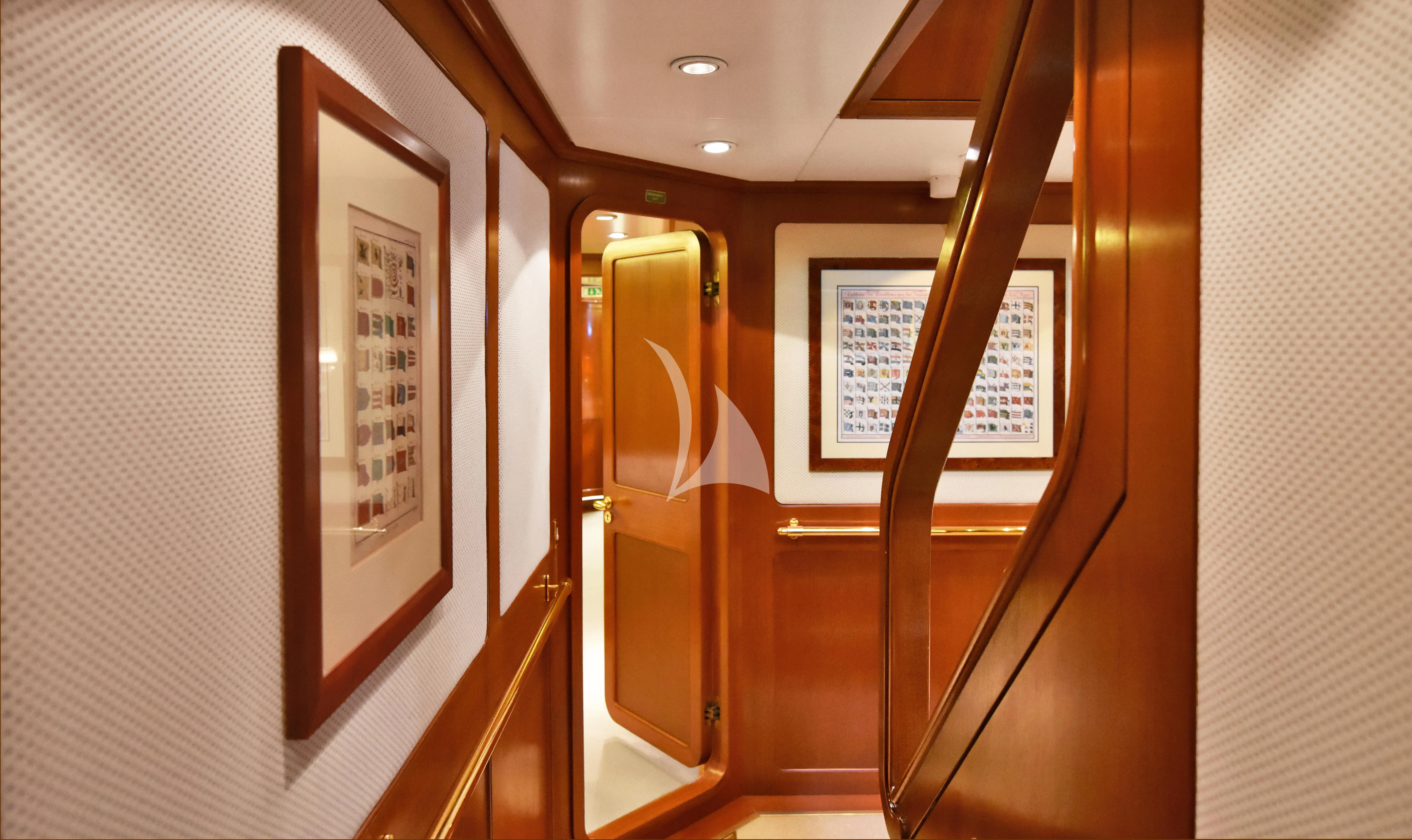 a hallway with a door and a sign on the wall aboard TAMARITA Yacht for Sale