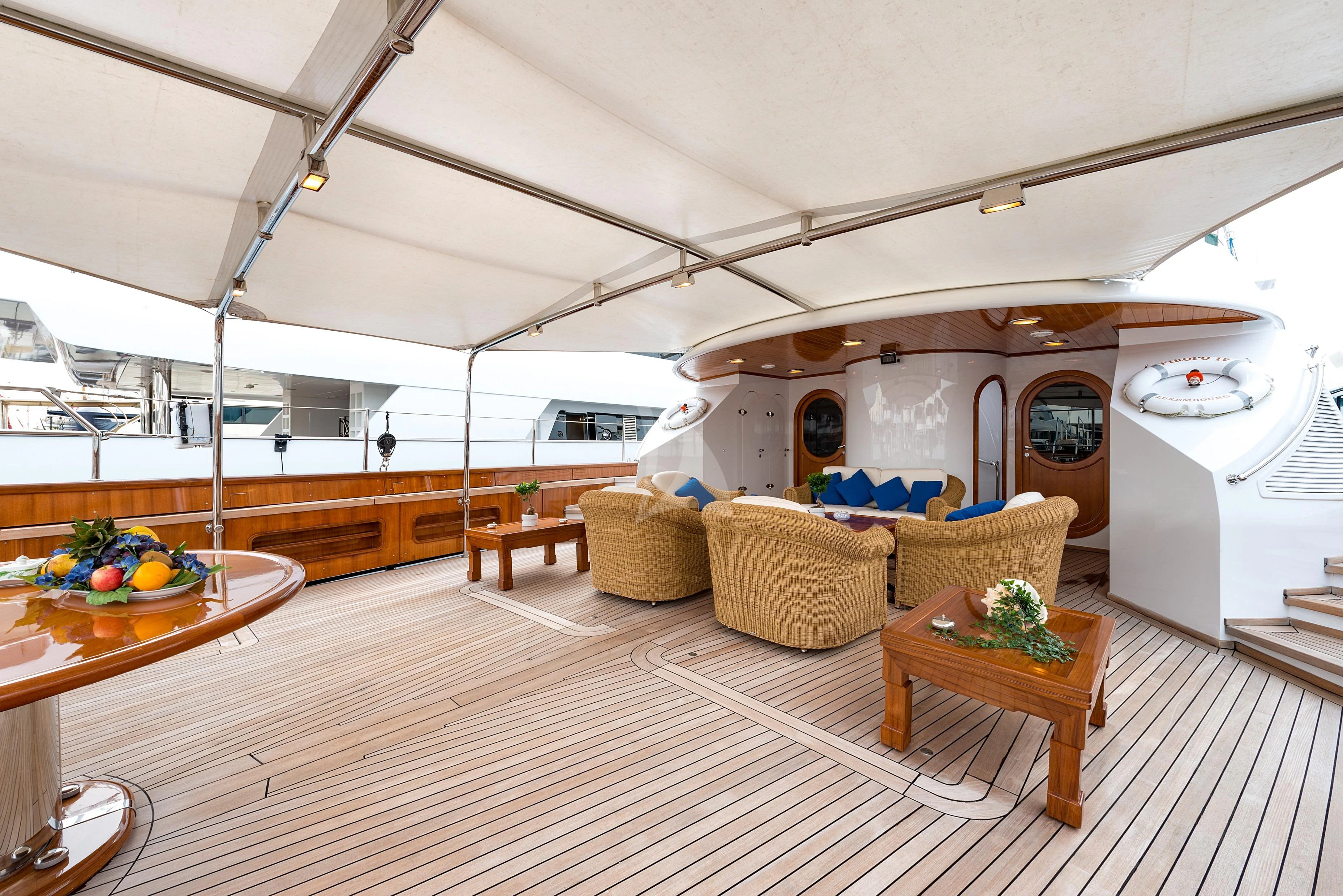 a kitchen with a table and chairs aboard TAMARITA Yacht for Sale