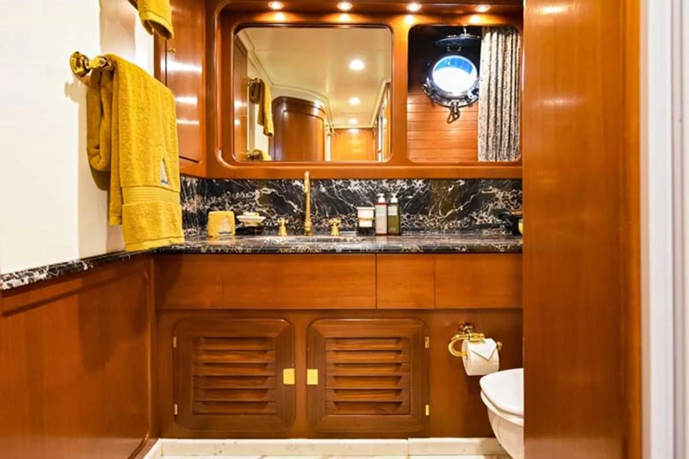 a bathroom with a sink and a mirror aboard TAMARITA Yacht for Sale