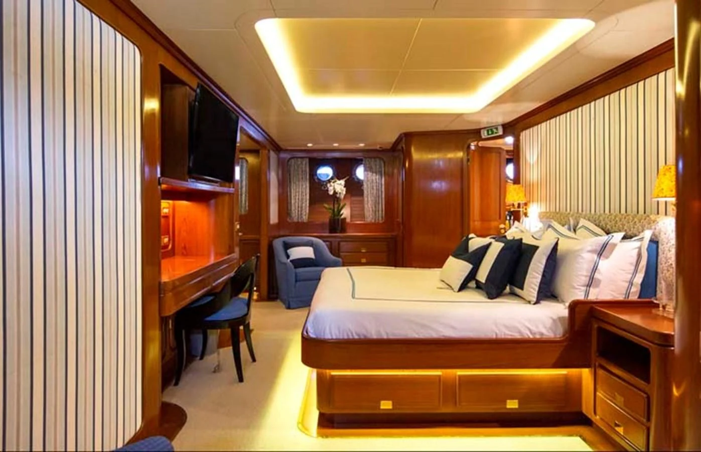 a room with a bed and a chair aboard TAMARITA Yacht for Sale
