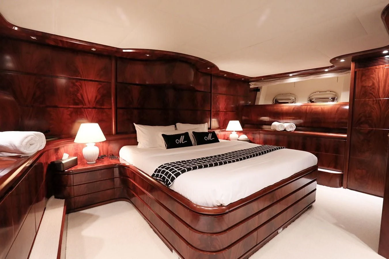 a room with a bed and a night stand aboard FOR YOUR EYES ONLY Yacht for Charter