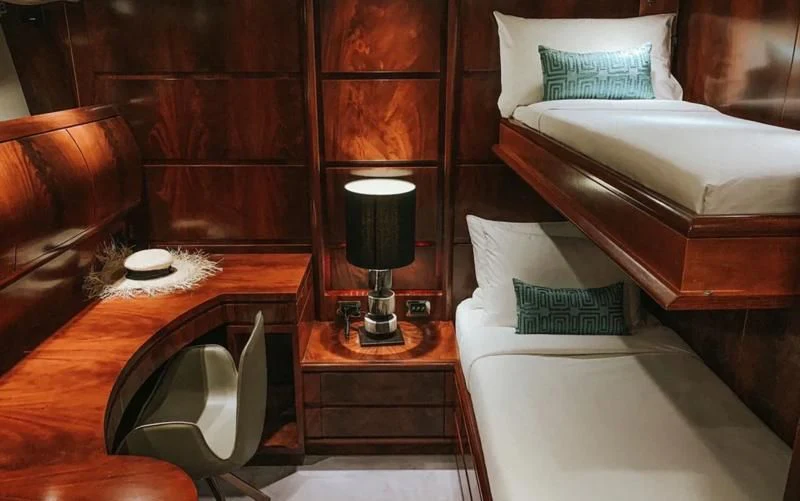 a room with a bed and a lamp aboard FOR YOUR EYES ONLY Yacht for Charter