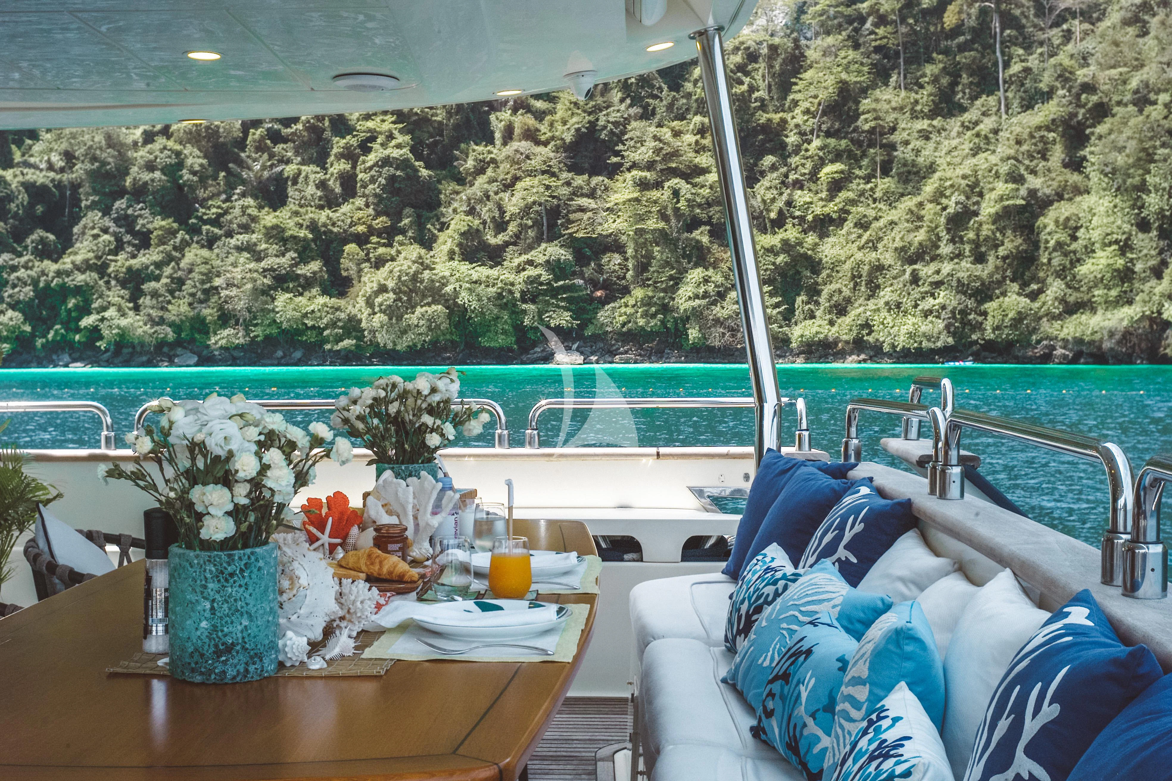a boat with a table and chairs aboard FOR YOUR EYES ONLY Yacht for Charter