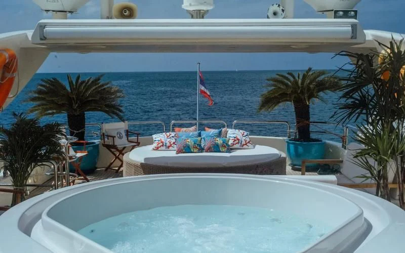 a pool with a beach and a building in the background aboard FOR YOUR EYES ONLY Yacht for Charter