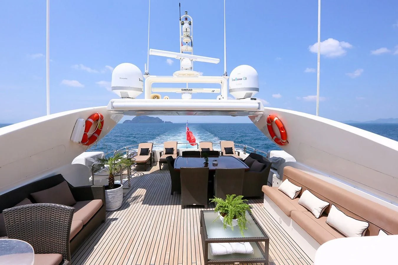 a deck with chairs and a large ship in the background aboard FOR YOUR EYES ONLY Yacht for Charter