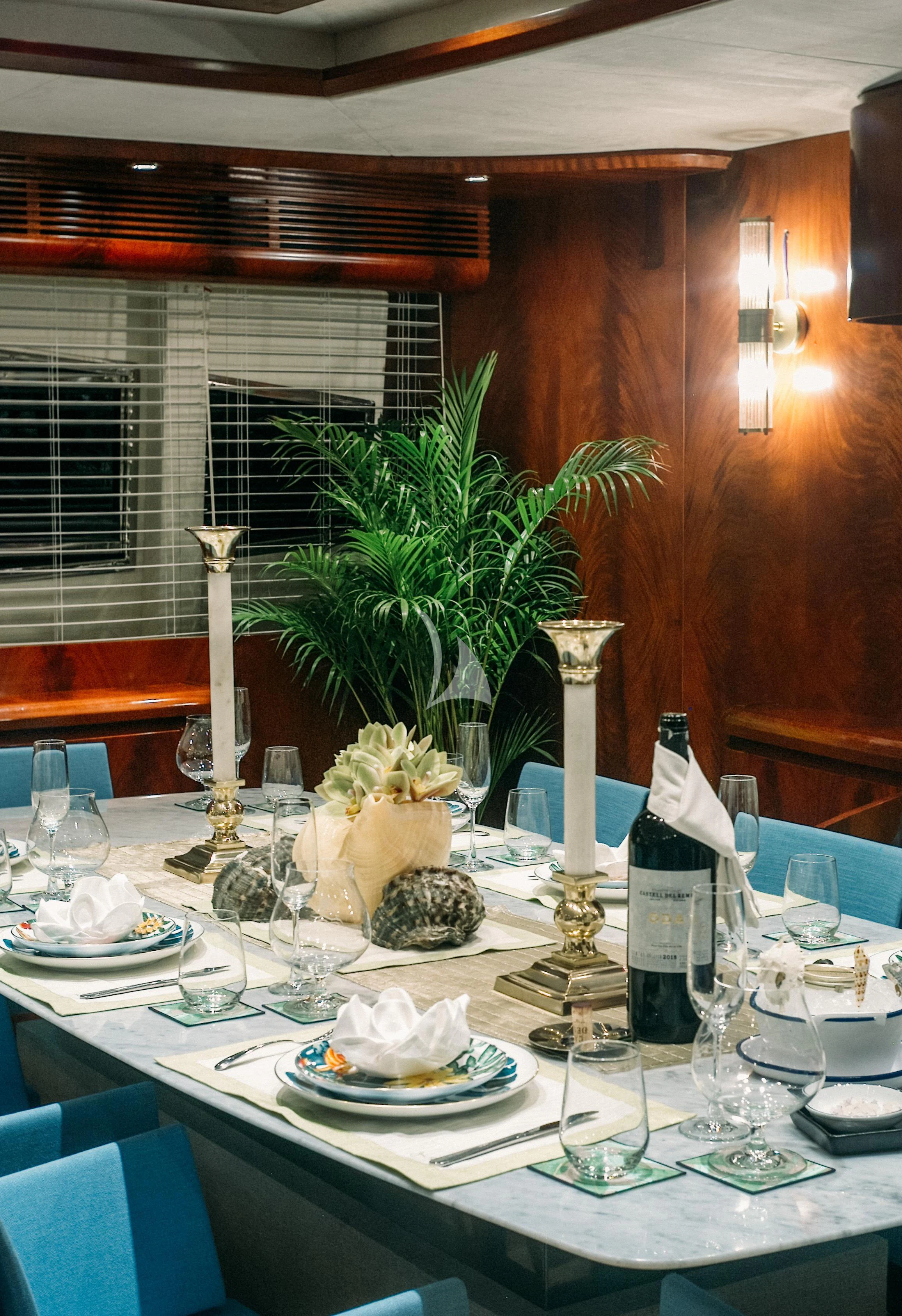a table with plates and vases aboard FOR YOUR EYES ONLY Yacht for Charter