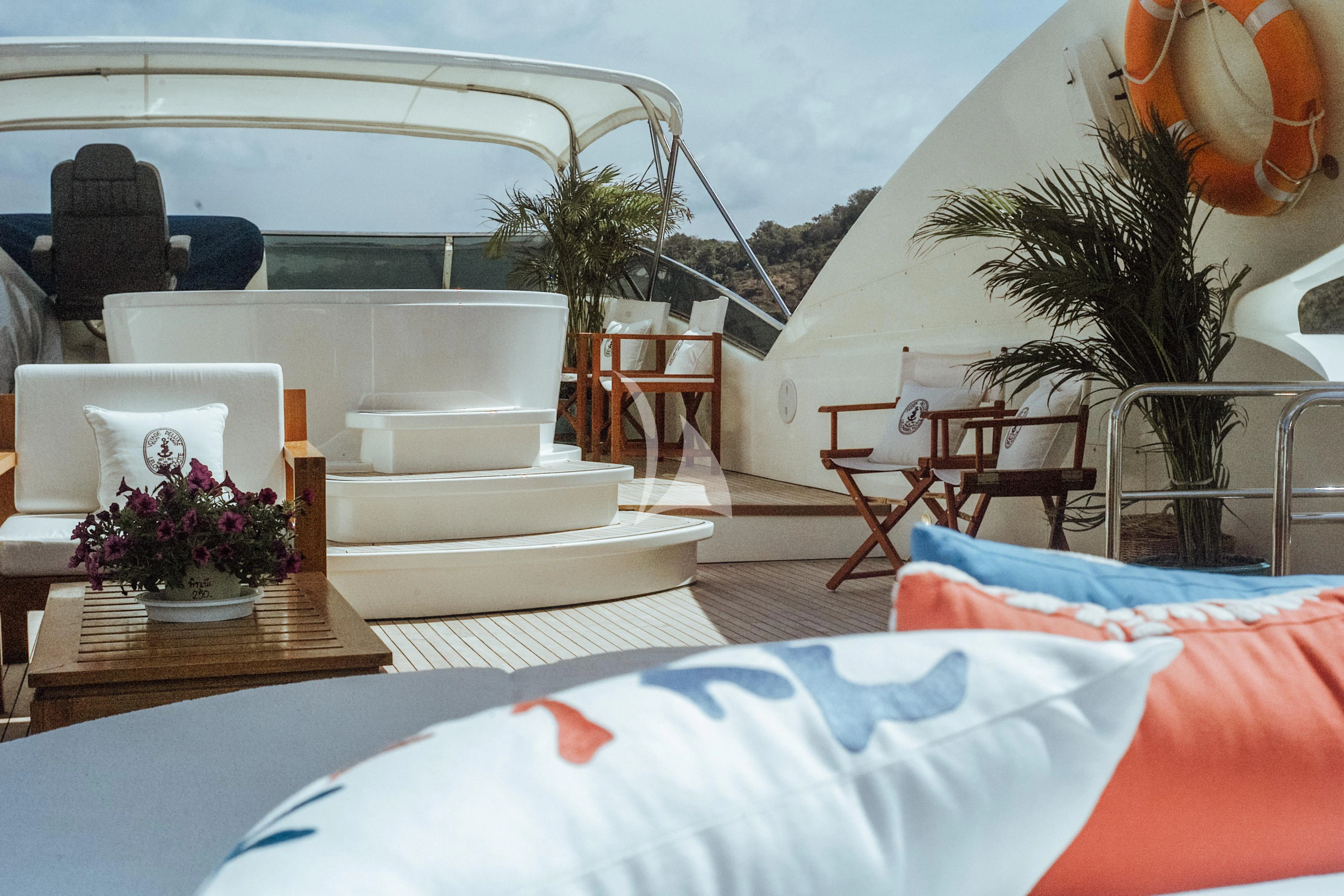 a room with a bed and a table and chairs aboard FOR YOUR EYES ONLY Yacht for Charter