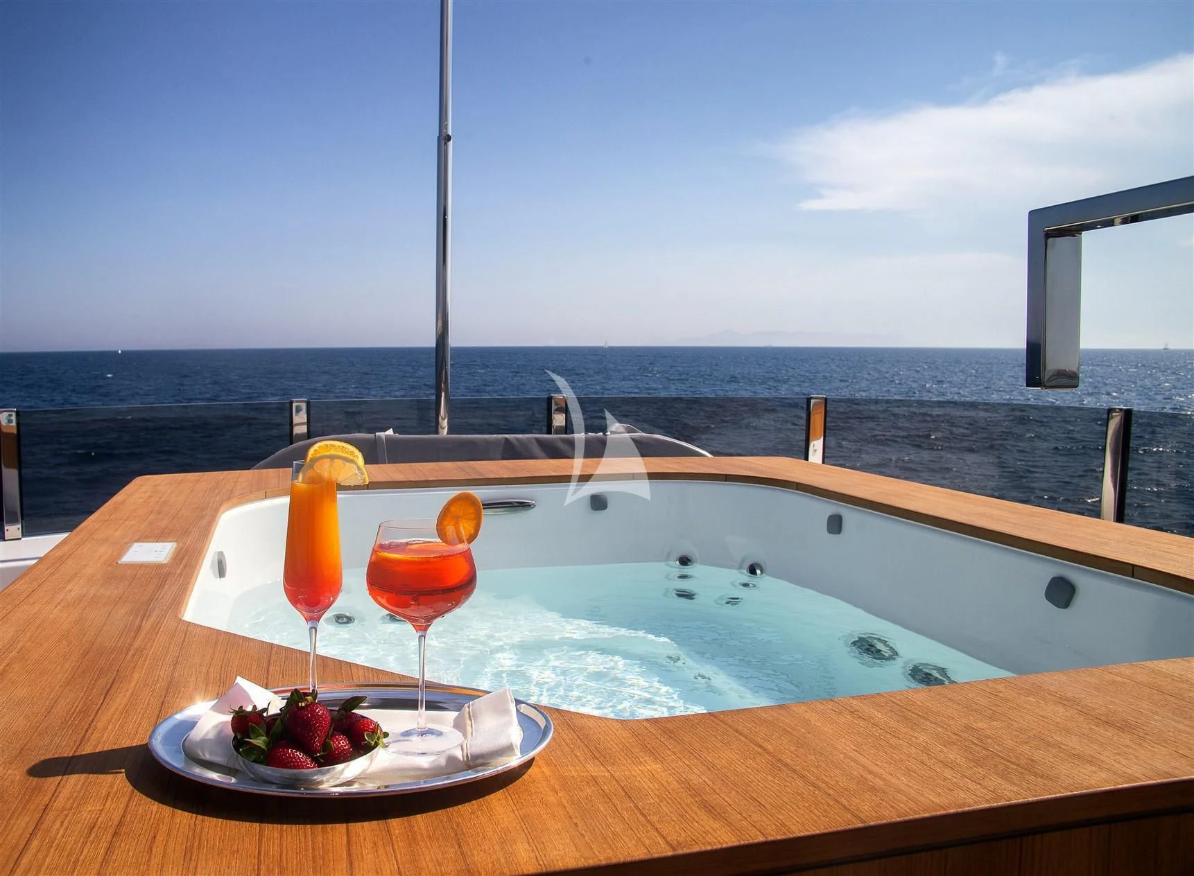 a table with drinks and fruits on it by a pool aboard HAIAMI I Yacht for Charter