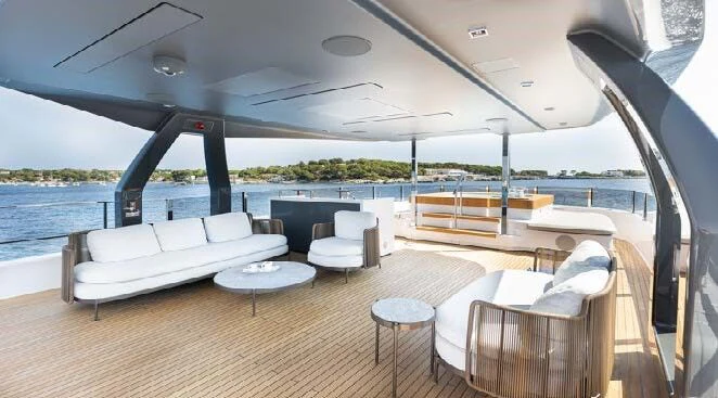a large lounge area with a large deck and a view of the water aboard HAIAMI I Yacht for Charter