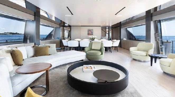 a living room with a large sofa and a table aboard HAIAMI I Yacht for Charter