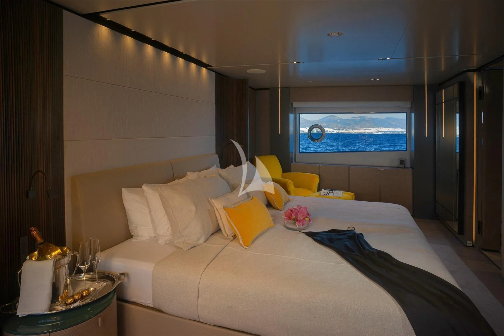 a bed with yellow pillows aboard HAIAMI I Yacht for Charter