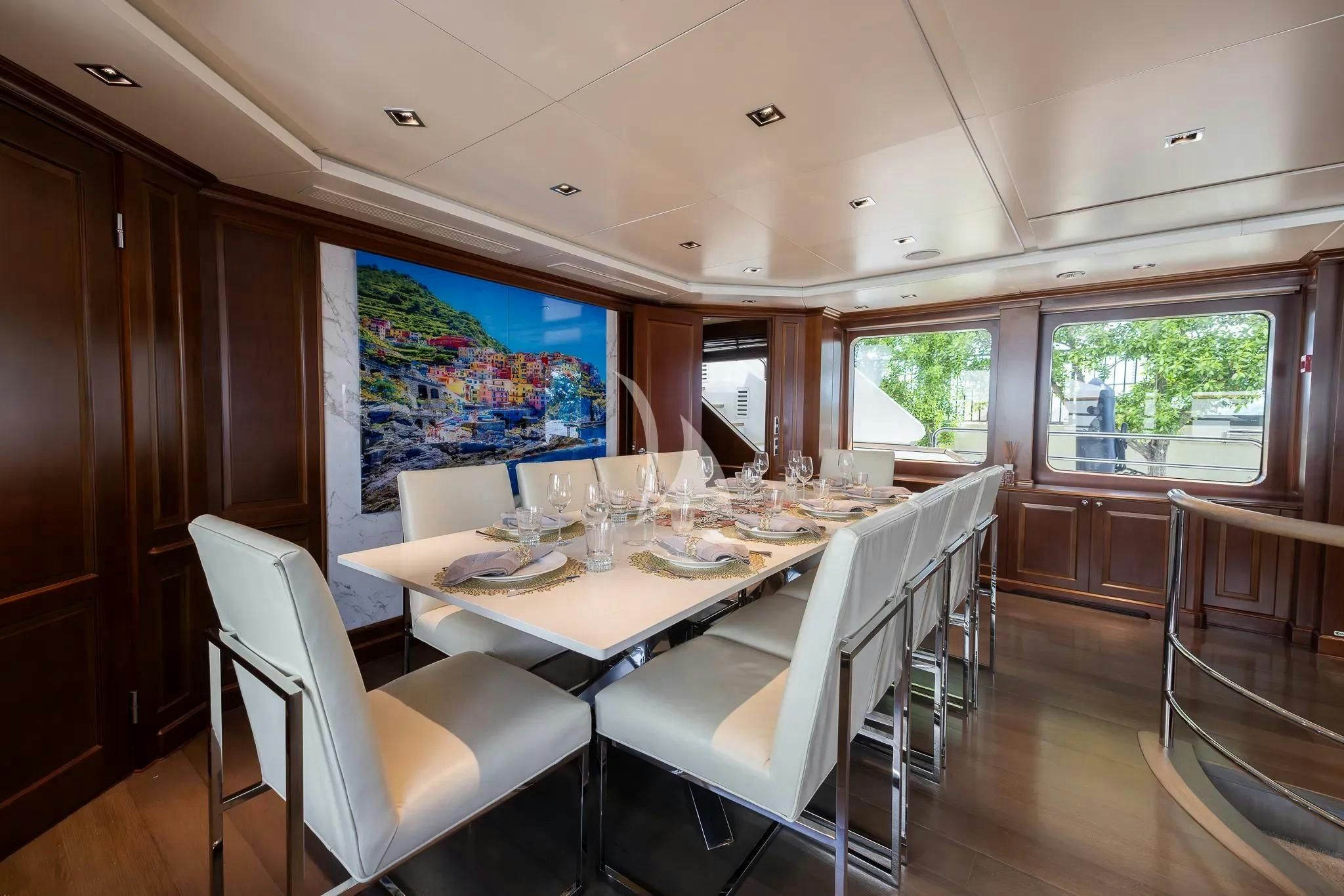 a dining room with white chairs aboard ARTHUR’S WAY Yacht for Sale