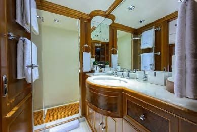 a bathroom with a large mirror aboard ARTHUR’S WAY Yacht for Sale