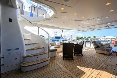 inside of a building with a table and chairs and a large window aboard ARTHUR’S WAY Yacht for Sale