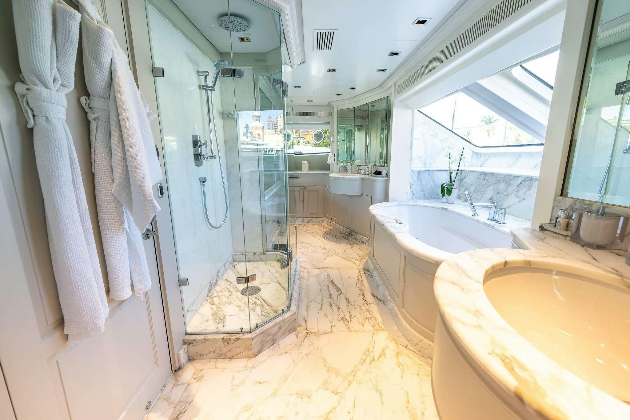 a bathroom with a tub sink and shower aboard ARTHUR’S WAY Yacht for Sale