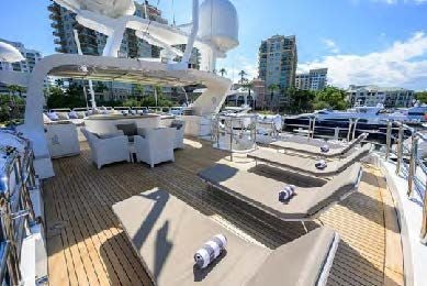 a deck with a large deck and a view of a city aboard ARTHUR’S WAY Yacht for Sale