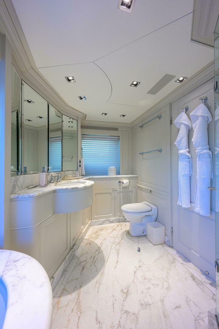 a bathroom with a tub sink and toilet aboard ARTHUR’S WAY Yacht for Sale