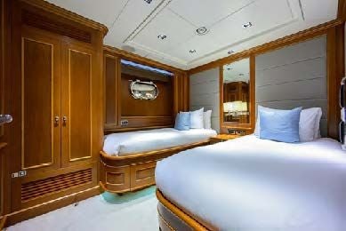 a room with a bed and a closet aboard ARTHUR’S WAY Yacht for Sale