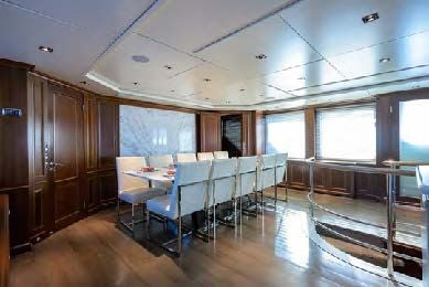 a room with tables and chairs aboard ARTHUR’S WAY Yacht for Sale