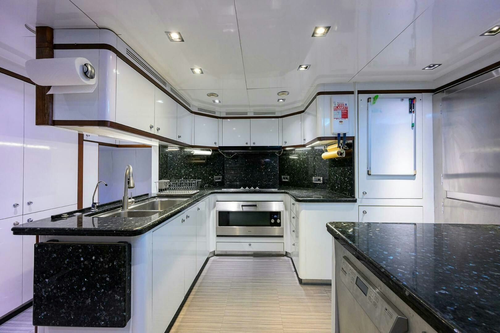 a kitchen with white cabinets aboard ARTHUR’S WAY Yacht for Sale