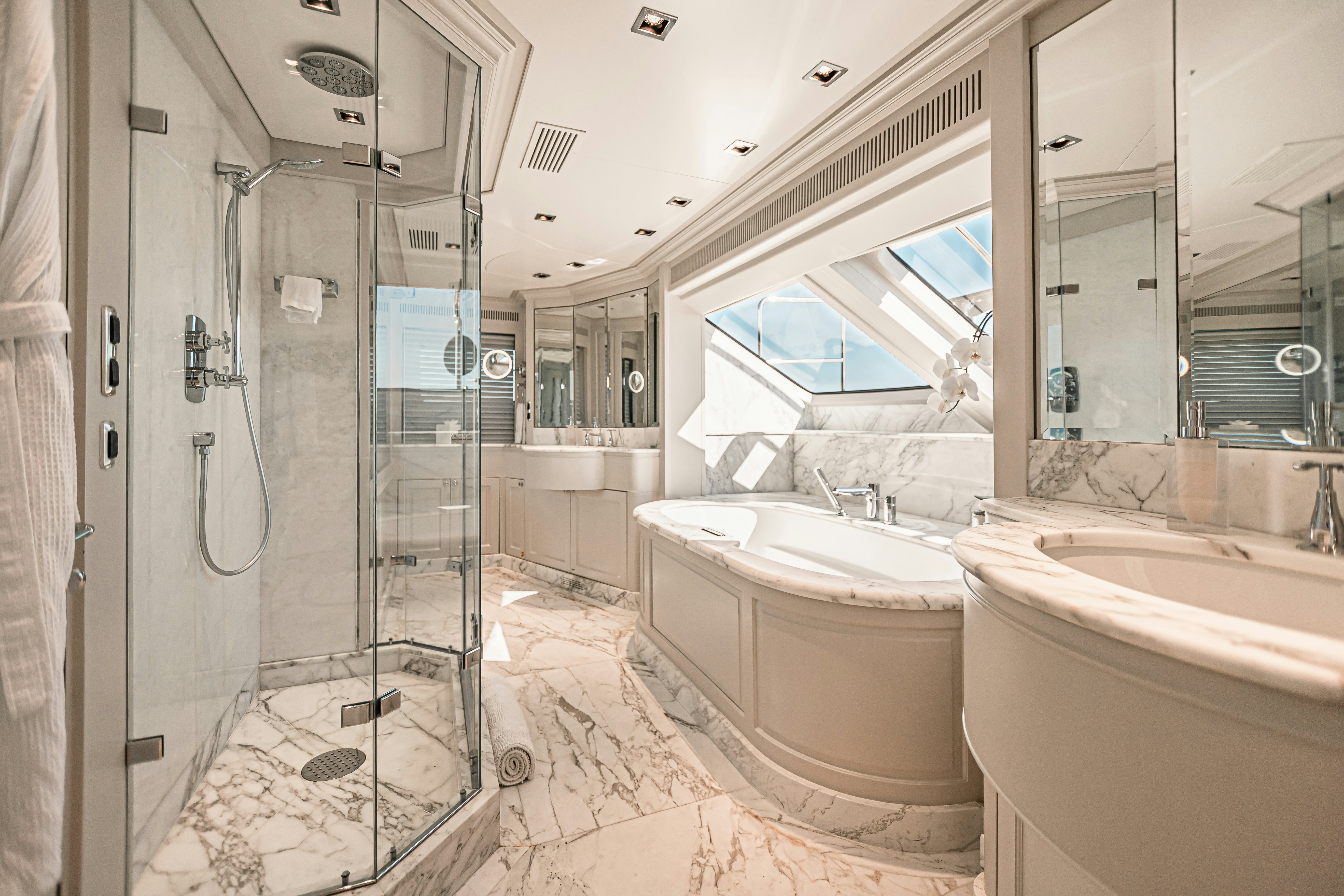 a bathroom with a glass shower aboard ARTHUR’S WAY Yacht for Sale