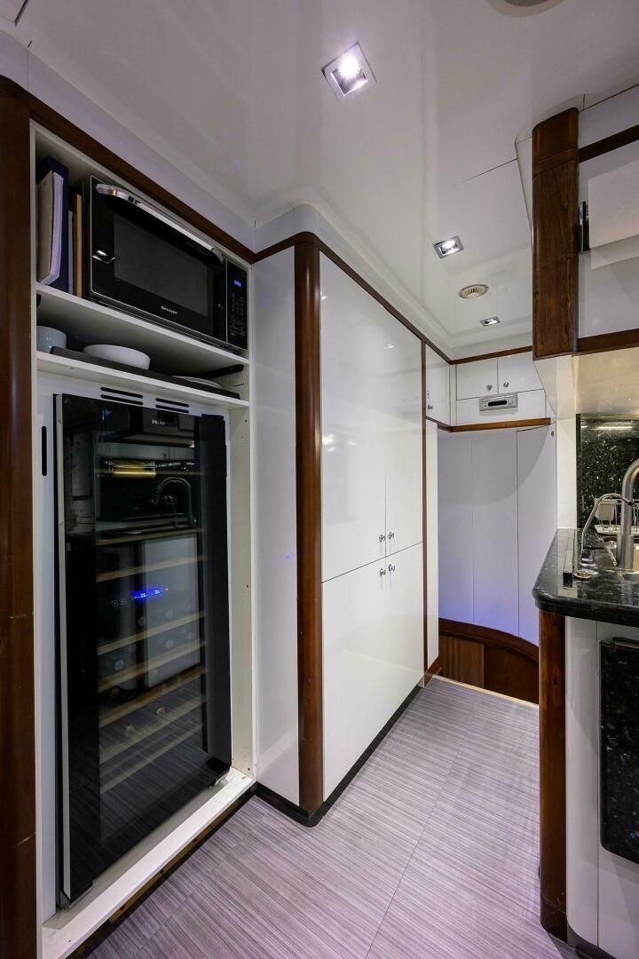 a room with a microwave and cabinets aboard ARTHUR’S WAY Yacht for Sale