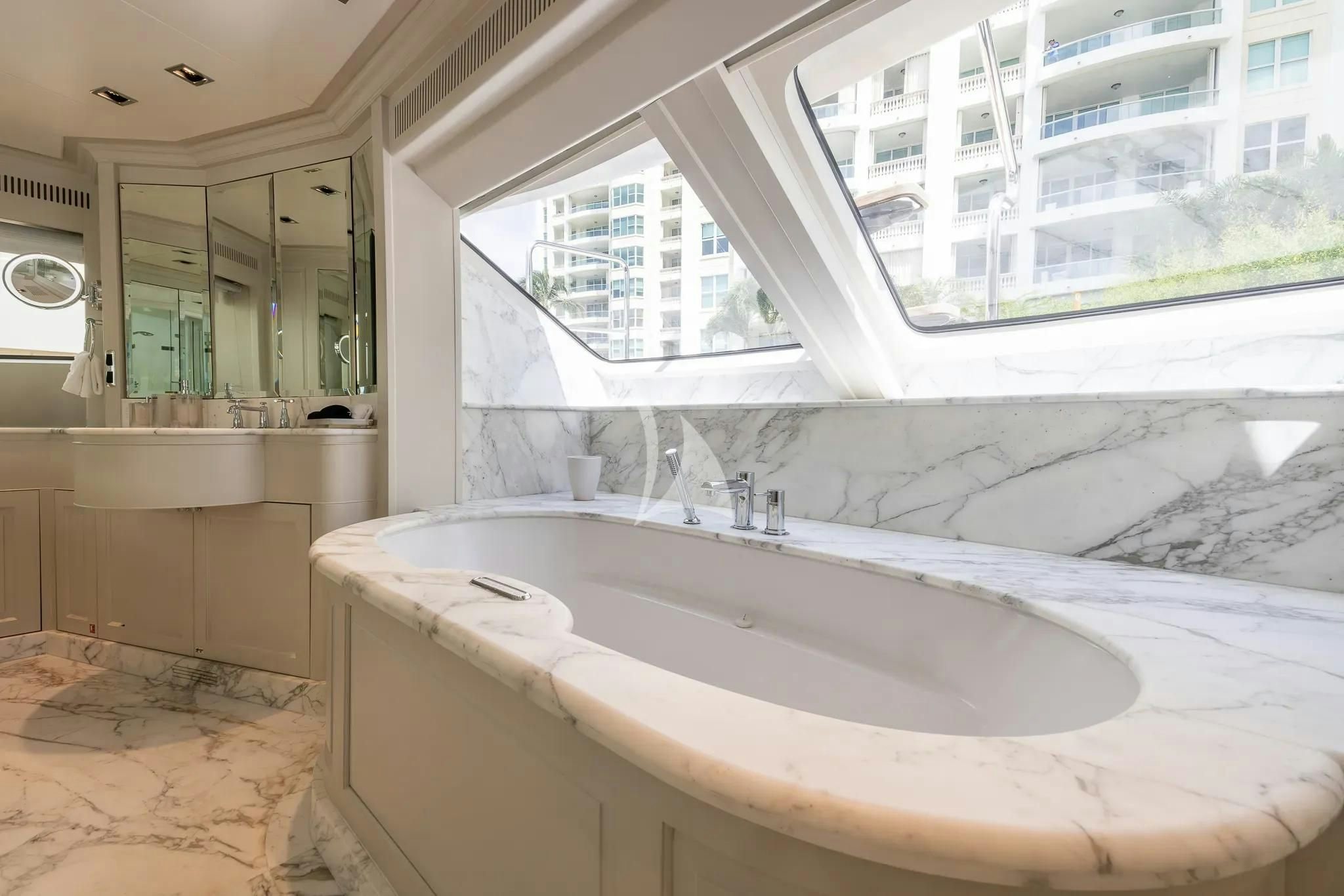 a bathroom with a large bathtub aboard ARTHUR’S WAY Yacht for Sale