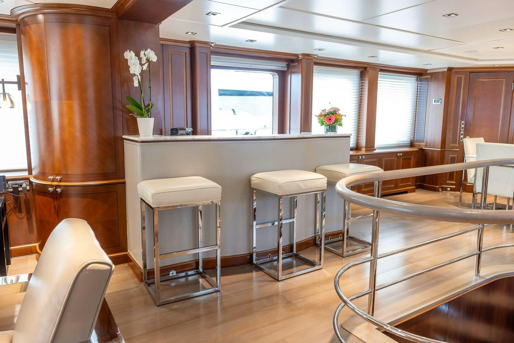 a room with tables and chairs aboard ARTHUR’S WAY Yacht for Sale