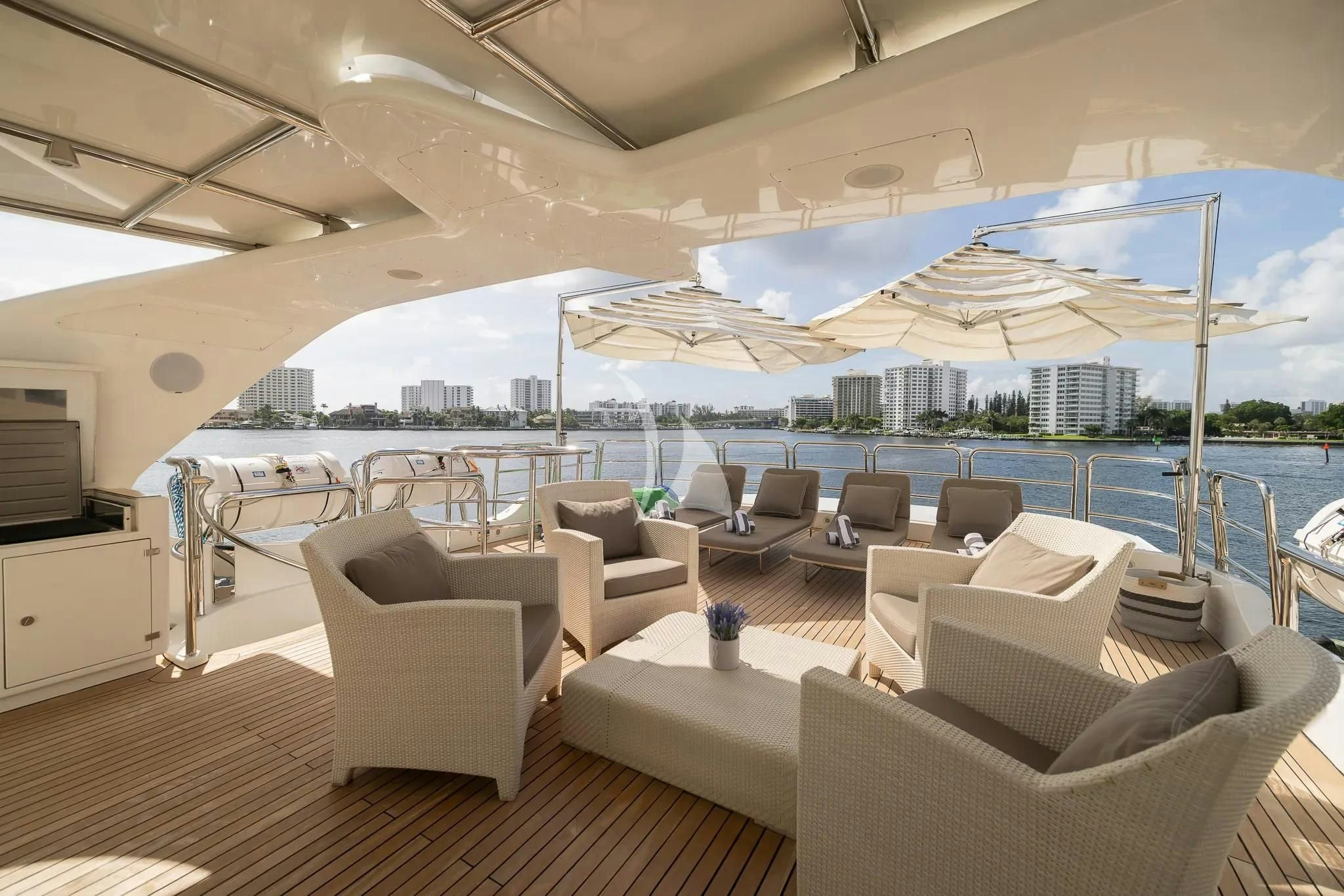 a large lounge area with a large white lounge chair and a large white umbrella aboard ARTHUR’S WAY Yacht for Sale