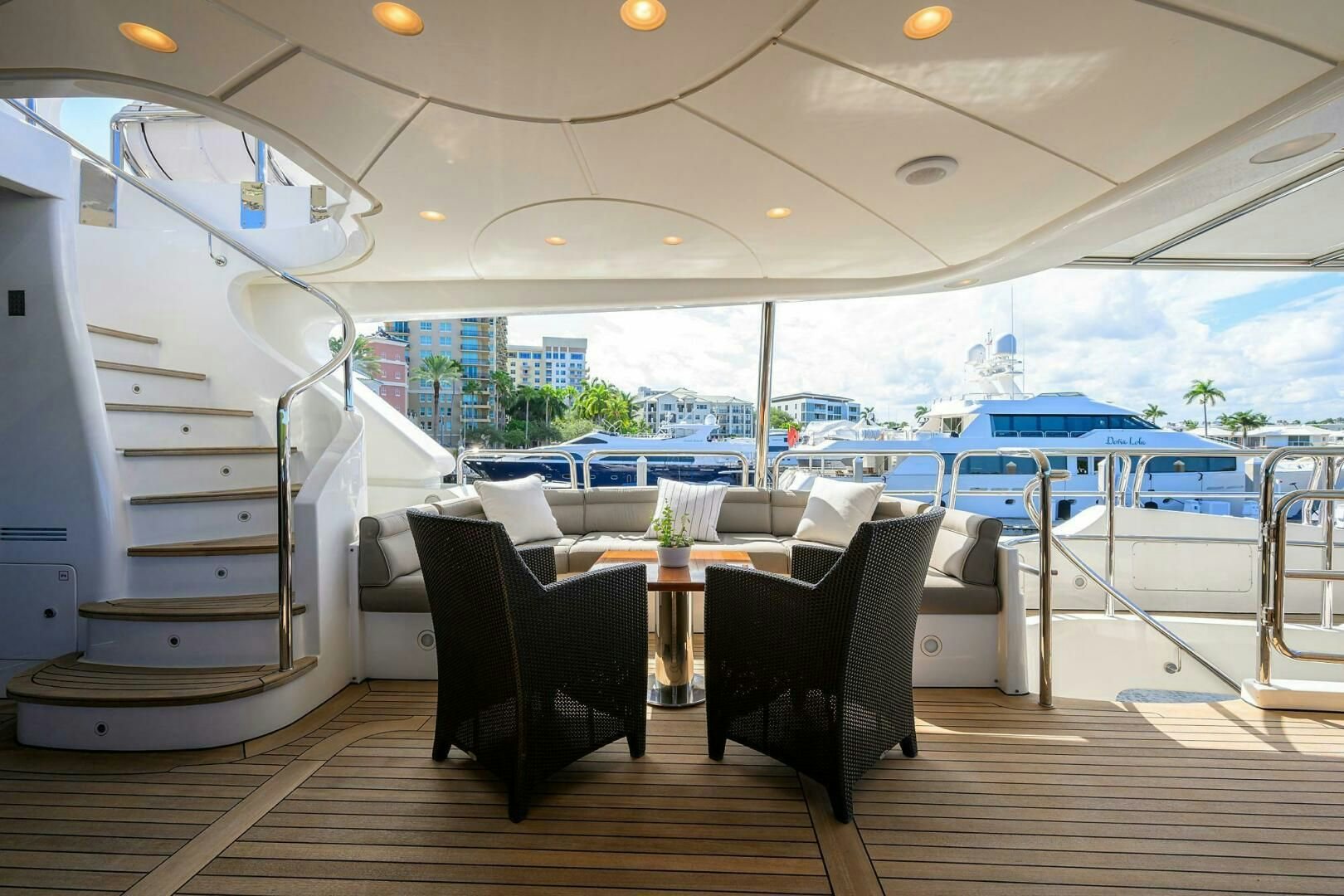 a room with a table chairs and a view of the city aboard ARTHUR’S WAY Yacht for Sale