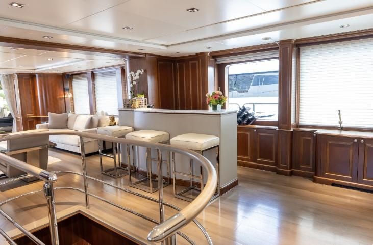 a living room with a kitchen and dining area aboard ARTHUR’S WAY Yacht for Sale