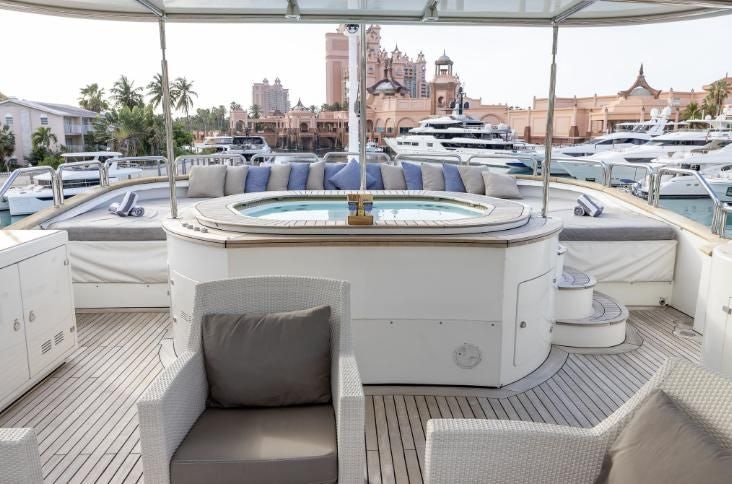 a table and chairs on a deck aboard ARTHUR’S WAY Yacht for Sale