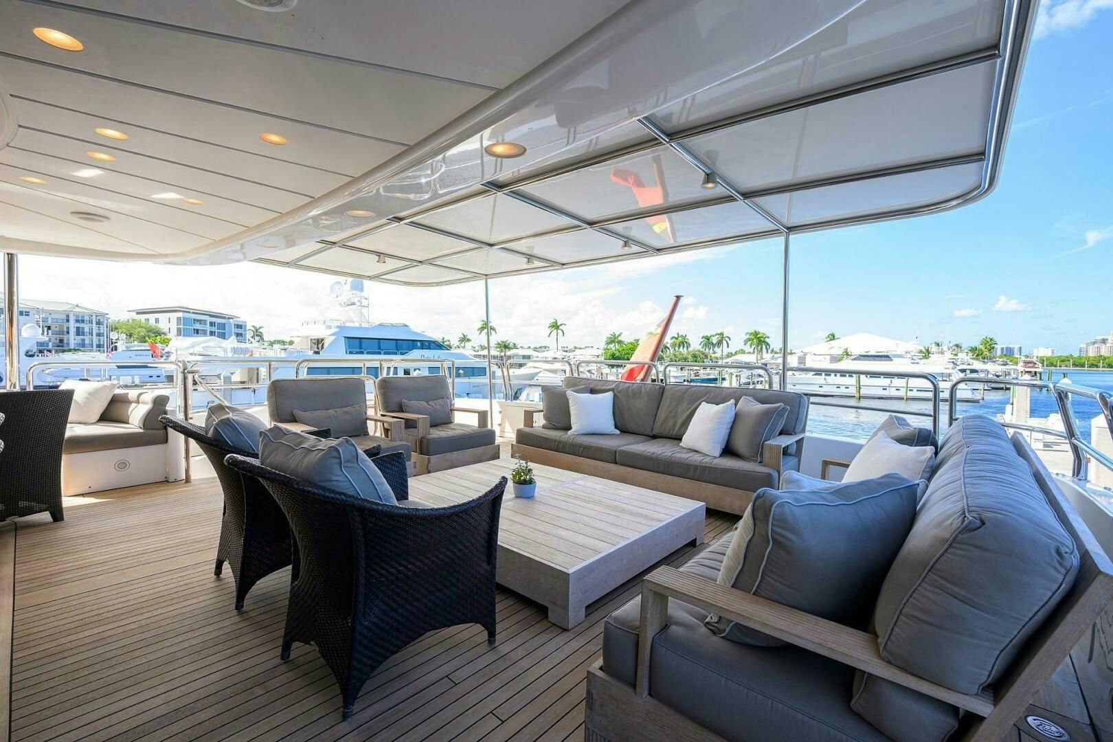 a large lounge area with couches and a table and chairs aboard ARTHUR’S WAY Yacht for Sale