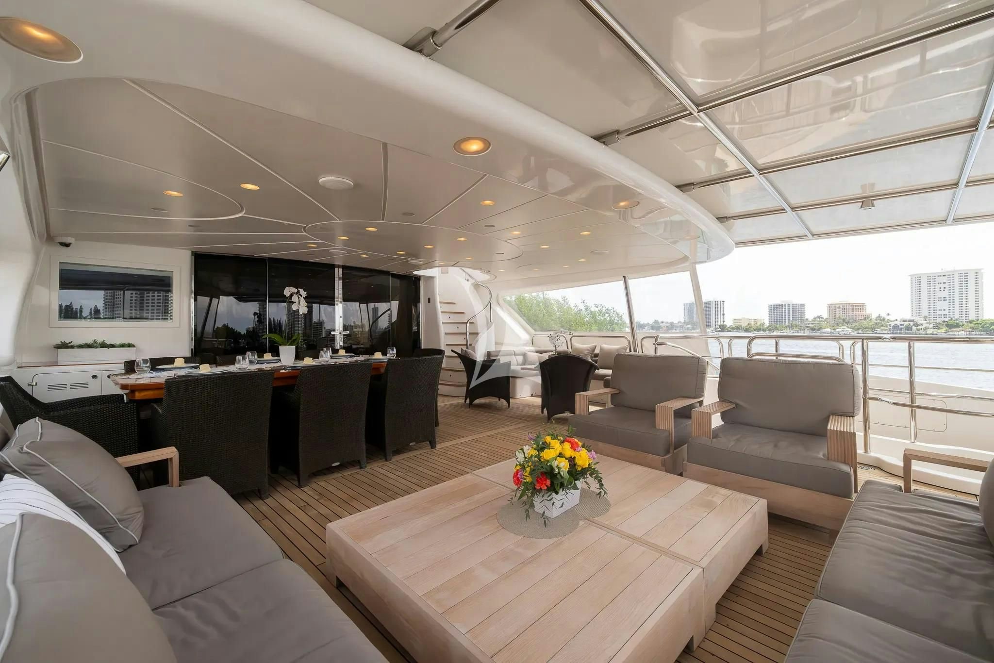 a room with couches and a table and chairs aboard ARTHUR’S WAY Yacht for Sale