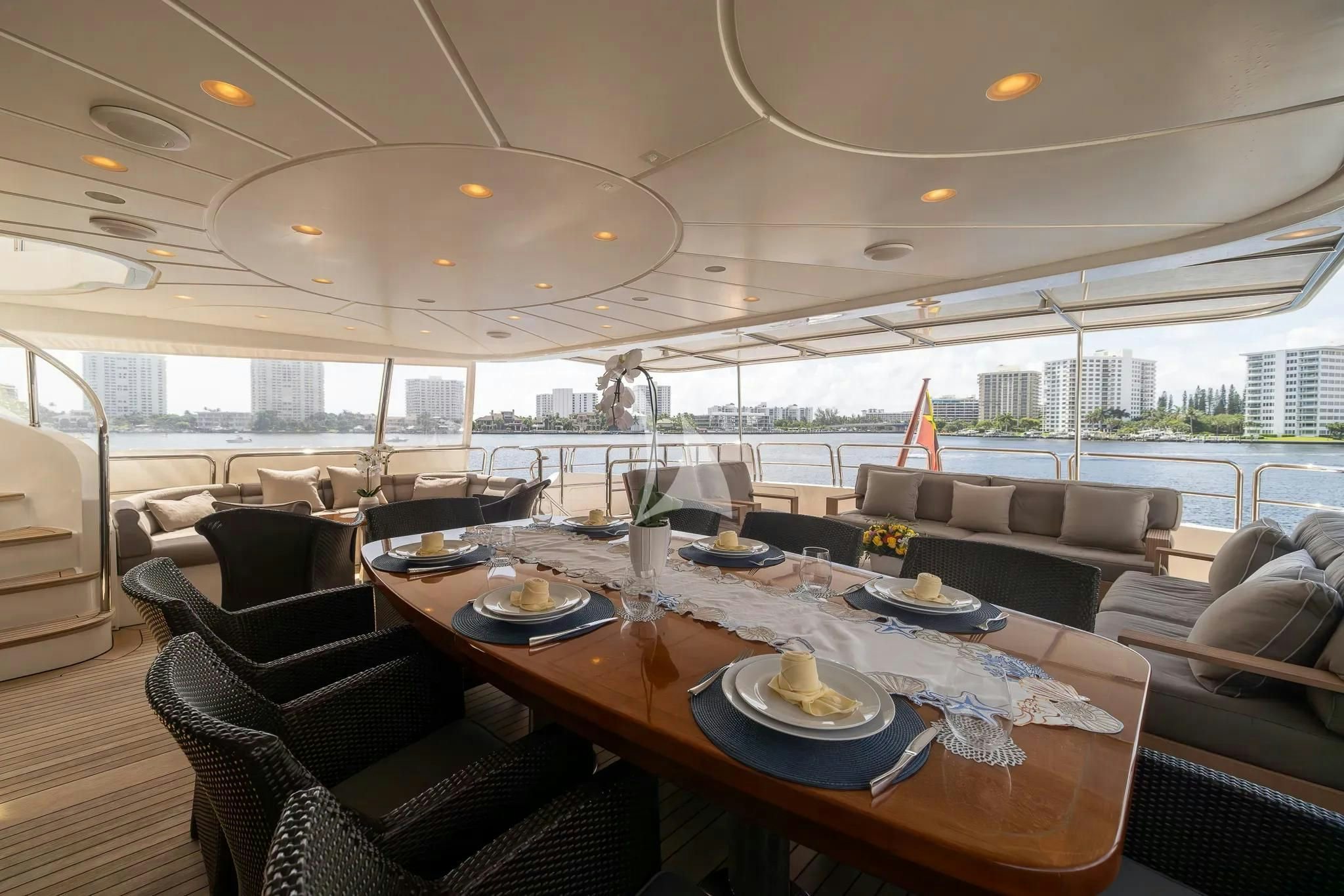 a dining room with a view of the city aboard ARTHUR’S WAY Yacht for Sale