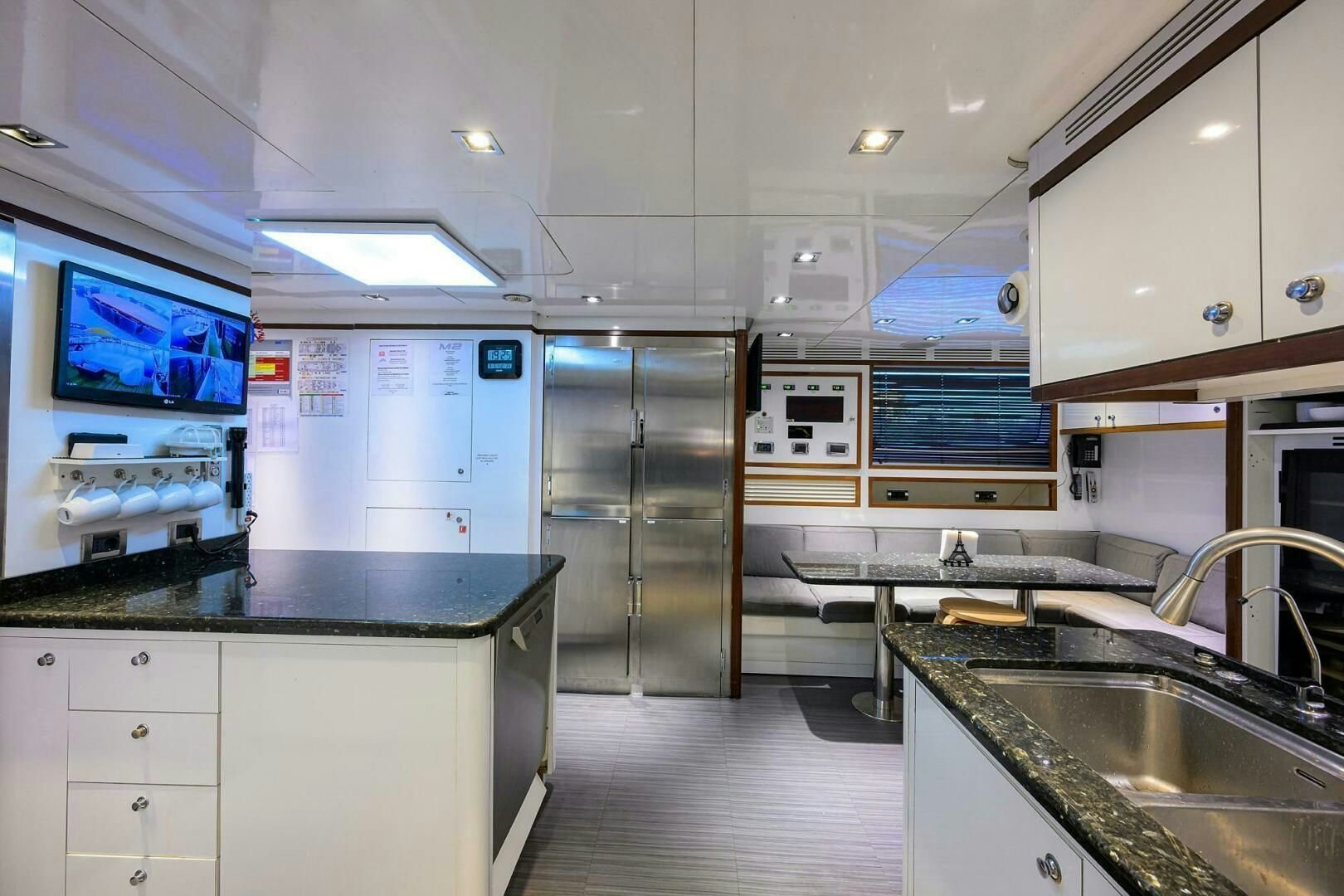 a kitchen with a fridge and a sink aboard ARTHUR’S WAY Yacht for Sale