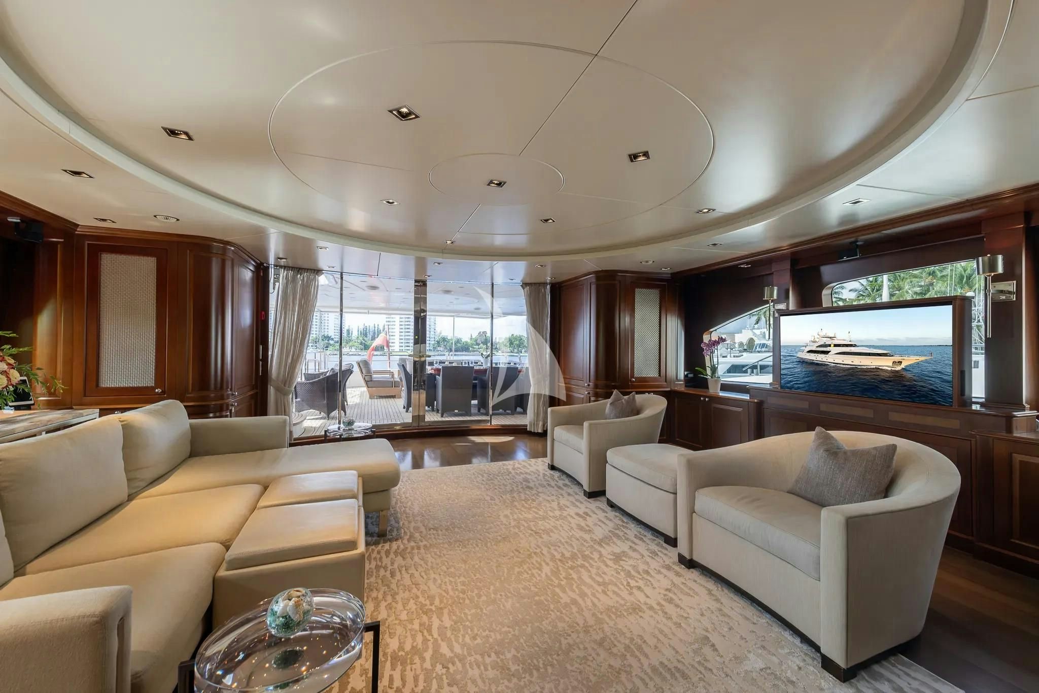a living room with a large screen aboard ARTHUR’S WAY Yacht for Sale