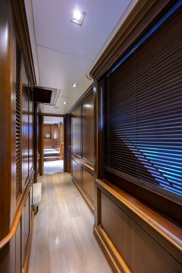 a hallway with a wood floor and a tv on the wall aboard ARTHUR’S WAY Yacht for Sale