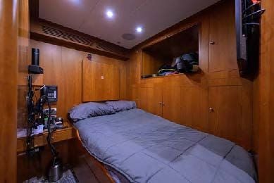 a bedroom with a bed and speakers aboard ARTHUR’S WAY Yacht for Sale