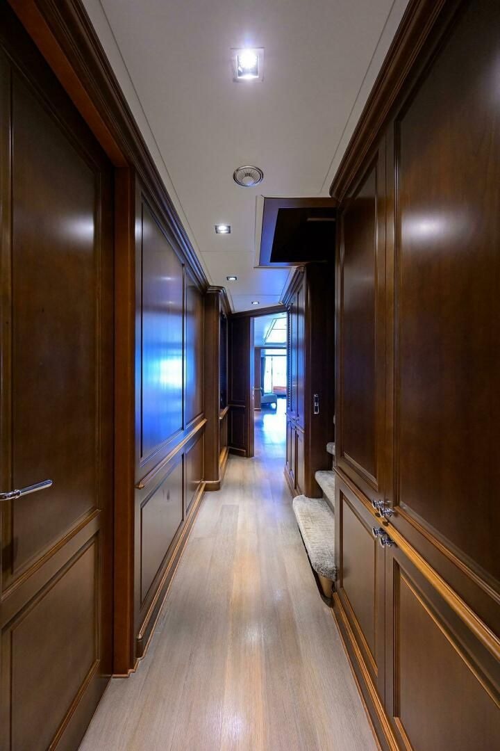 a hallway with a wood floor and a television on the wall aboard ARTHUR’S WAY Yacht for Sale