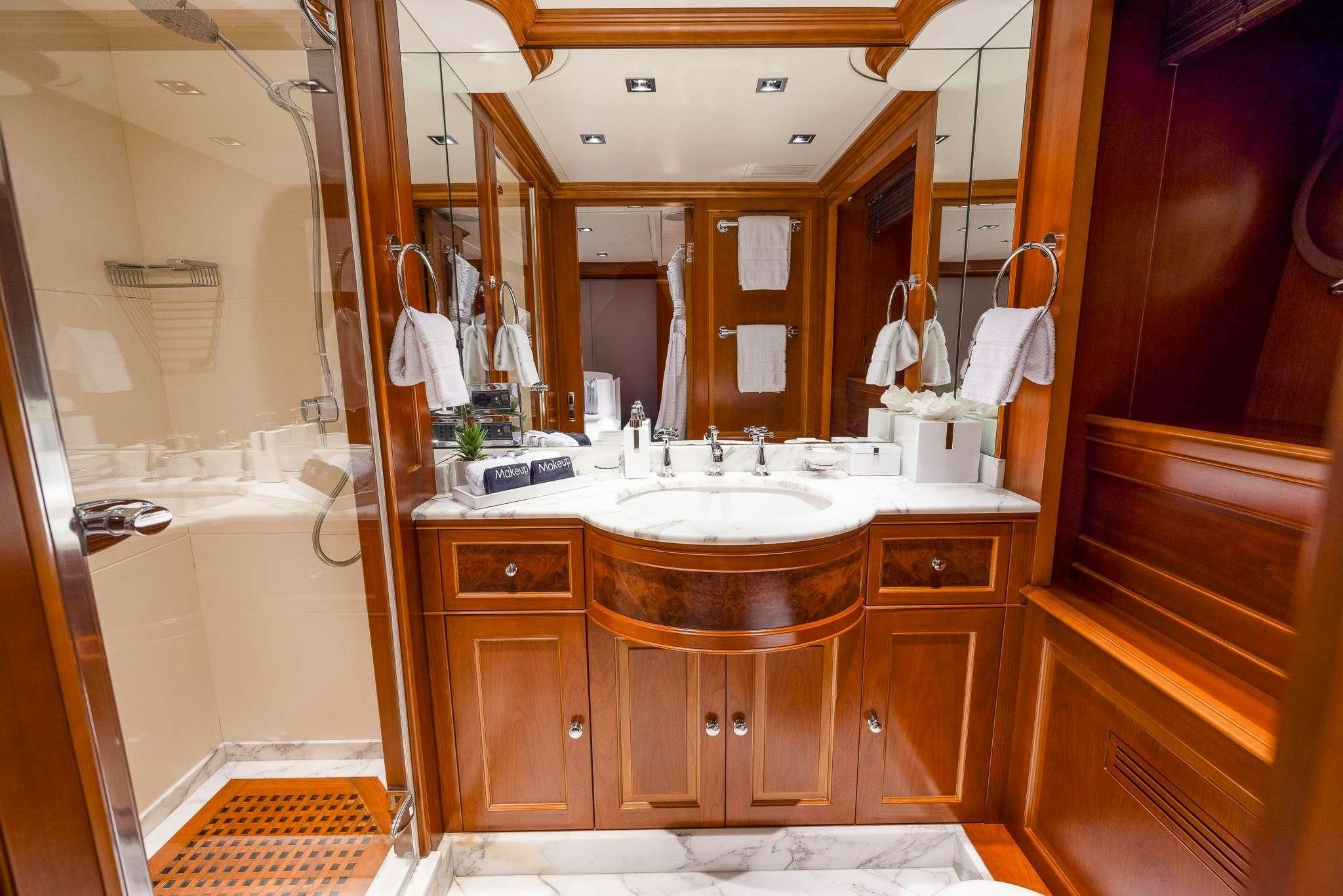 a bathroom with a large mirror aboard ARTHUR’S WAY Yacht for Sale