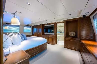 a bedroom with a bed and a desk aboard ARTHUR’S WAY Yacht for Sale