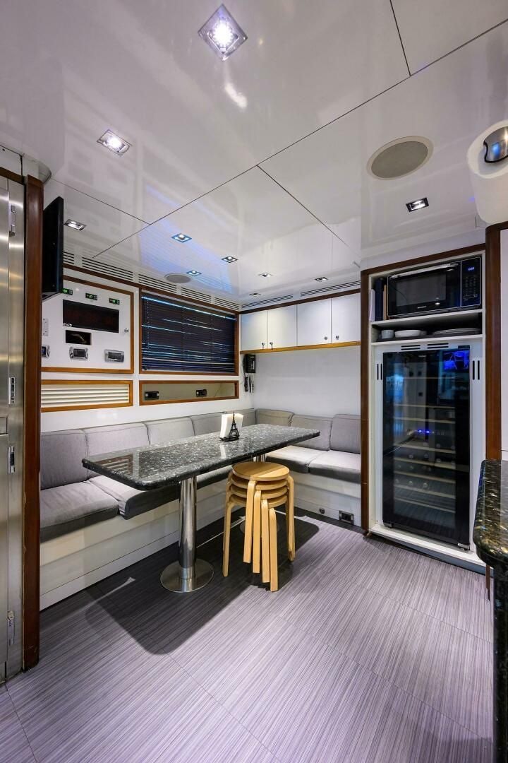 a kitchen with a table and chairs aboard ARTHUR’S WAY Yacht for Sale