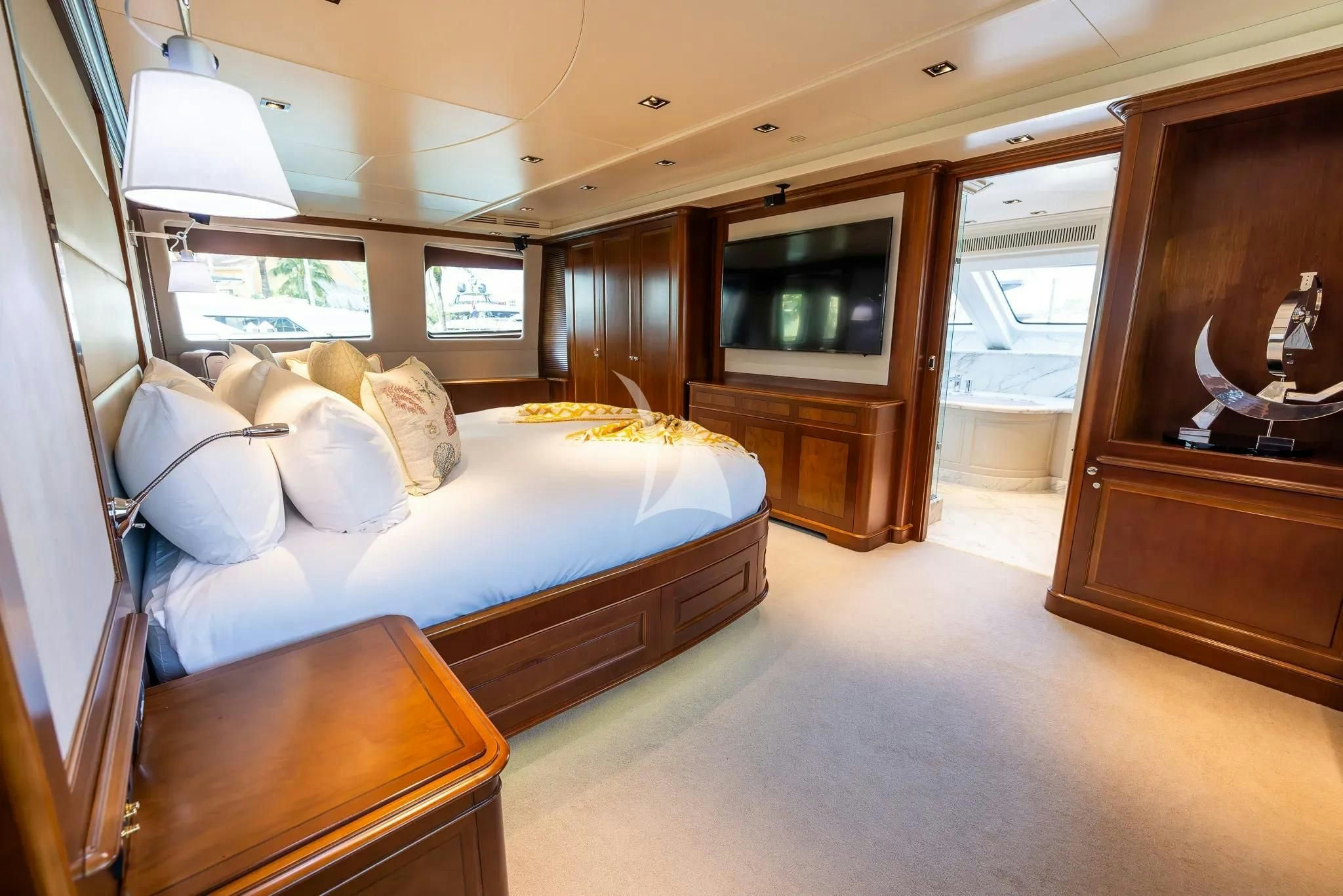 a bedroom with a bed and a dresser aboard ARTHUR’S WAY Yacht for Sale