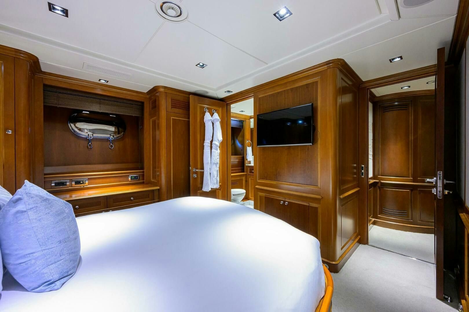a bedroom with a bed and a television aboard ARTHUR’S WAY Yacht for Sale