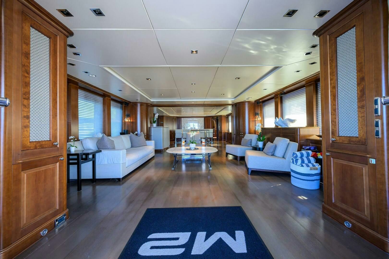 a living room with a table and couches aboard ARTHUR’S WAY Yacht for Sale